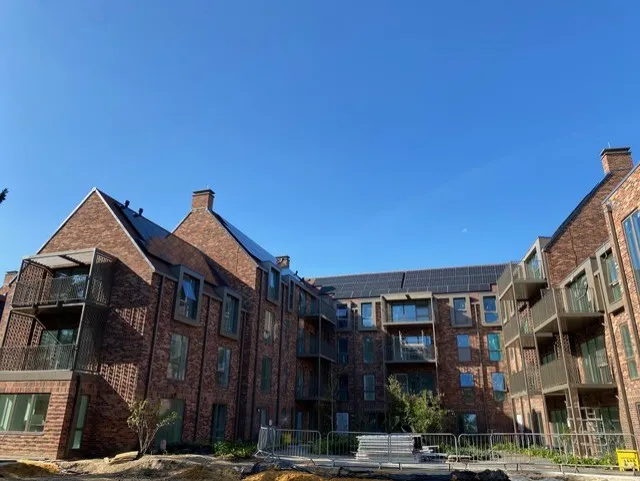 Multi-storey brick residential block with balconies, the type of building assessed in EWS1 and PAS9980 surveys